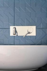 a bathroom with a sink with a magnifying glass on it at Hotel Baia di Talamone in Talamone +56 photos