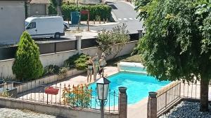 two women standing next to a swimming pool at Pierres et souvenirs in Usson-en-Forez