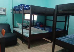 two bunk beds in a room with a couch at Monique Beach Resort by Hiverooms in Carmen +11 photos