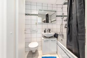 a white bathroom with a toilet and a sink at Global Bnb - Loft 28 Blue in Augsburg +36 photos