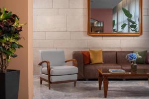 a living room with a couch and a chair at NH Ancona in Ancona