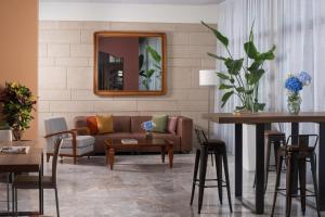 a living room with a couch and a table at NH Ancona in Ancona