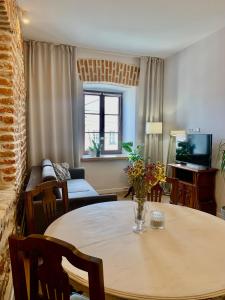 a living room with a table and a couch at Apartamenty Magdalena in Lublin