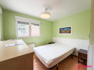 a small bedroom with a bed and a desk at Udeville in Oropesa del Mar
