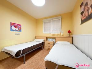 two beds in a room with yellow walls at Udeville in Oropesa del Mar +48 photos