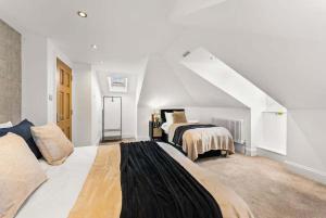 a bedroom with two beds in a attic at Seafront Duplex Worthing Beach - Sea Views 8 Guests in Worthing
