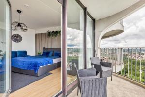 a bedroom with a bed and a balcony at Global Bnb - Loft 28 Blue in Augsburg