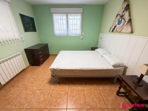 a bedroom with a bed and a dresser in it at Udeville in Oropesa del Mar