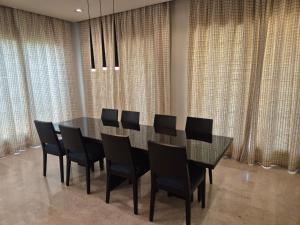a dining room with a black table and black chairs at منتجع موفون بيتش in Al Khobar +52 photos