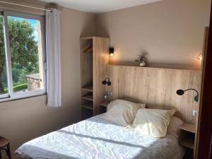 a bed in a bedroom with a window and a bed sidx sidx sidx at "Le Pigeonnier" chambre d'hôte in Piégros-la-Clastre