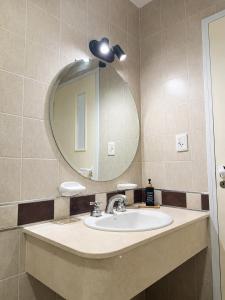 a bathroom with a sink and a mirror at Paramont Rosario 4 in Rosario de la Frontera +9 photos