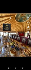 a long table with many plates of food on it at Айкол Этно Комплекс in Tong