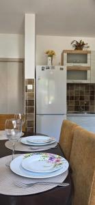 a kitchen with a table with two plates on it at Apartman Mara in Risan +10 photos