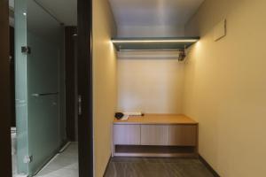 a bathroom with a wooden vanity and a glass door at Legong Keraton Beach Hotel in Canggu