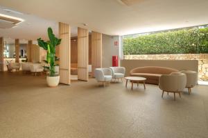a lobby with a waiting room with a couch and chairs at Cabot Cala Ferrera in Cala d´Or +78 photos