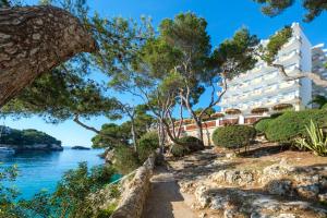 a view of the hotel from the water at Cabot Cala Ferrera in Cala d´Or