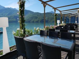 a table with chairs and a view of a lake at Mobile homes for 4 people with lake view in Residence L'Ecrin du Lac, Chorges in Chorges