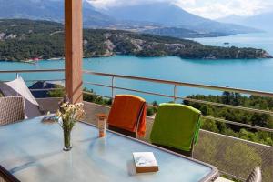 a table on a balcony with a view of the water at Mobile homes for 4 people with lake view in Residence L'Ecrin du Lac, Chorges in Chorges +66 photos