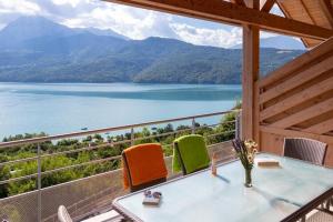 a balcony with a view of a lake at Mobile homes for 4 people with lake view in Residence L'Ecrin du Lac, Chorges in Chorges