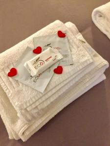 a pile of towels with hearts on top of them at Amedeo Square in Naples