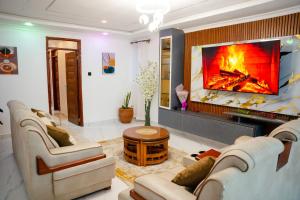 a living room with a fireplace and a tv at LIBERTY TOWERs in Lower Kabete