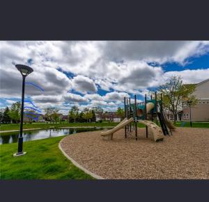 a playground with a slide in a park at Joykip's place in West Des Moines