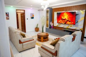 a living room with two couches and a fireplace at LIBERTY TOWERs in Lower Kabete +5 photos