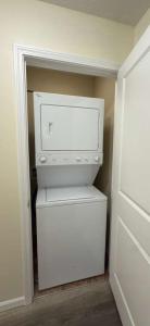 a small white refrigerator in a small room at Joykip's place in West Des Moines