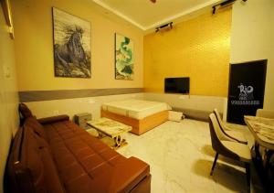 a living room with a couch and a tv at RIO POOL VILLAS in Chīrāla +10 photos