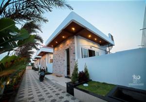 a house with a pathway in front of it at RIO POOL VILLAS in Chīrāla