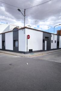 a white building on the side of a street at AniCa III De Cine in Tomelloso
