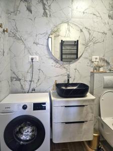 a bathroom with a washing machine and a sink at Apartments Lorena Mljet in Pomena +114 photos