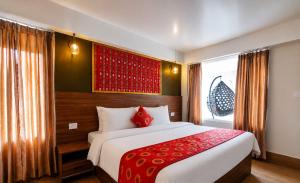 a bedroom with a large bed and a window at The Pham Inn in Bomdila