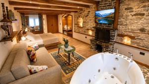 a living room with a couch and a fireplace at Cumaku Boutique Hotel & Spa in Gjirokastër