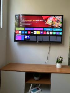 a flat screen tv hanging on a wall at Excellent value for money - Fully equipped apartment in Macaé