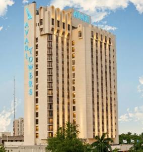a large white building with a hotel sign on it at Avari Towers Karachi in Karachi