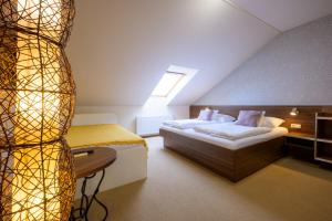 a bedroom with a bed and a table in a room at Apartmán Bílá Hora - Plzeň in Pilsen +27 photos