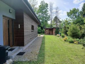 a house with a yard next to a building at Bungalov v Krásné Lípě in Krásná Lípa