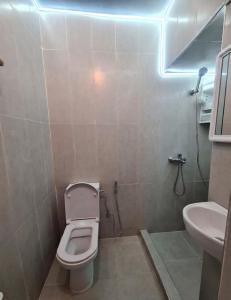 a small bathroom with a toilet and a sink at Kasbah Nights Retreat and best breakfast offers - Entire House in Tangier