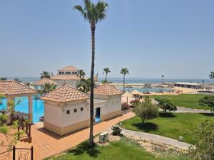 a view of a resort with a palm tree at منتجع موفون بيتش in Al Khobar