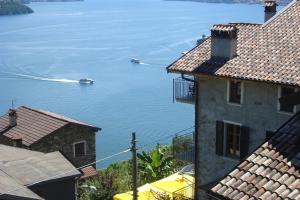 a view of a body of water between two buildings at Amarone Classica in Gravedona