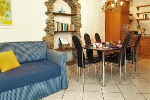 a dining room with a table and a blue couch at Amarone Classica in Gravedona