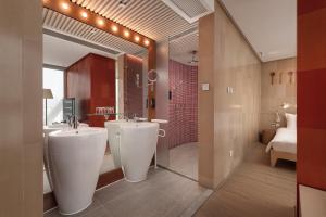a bathroom with two sinks and a large mirror at Hotel Madera Hong Kong in Hong Kong +27 photos