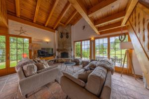 a large living room with couches and a tv at Chalet Pierre Blanche in Nendaz