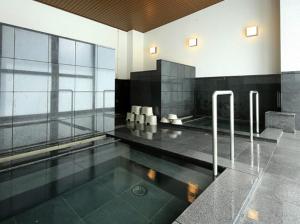 a swimming pool in a building with a glass wall at Nikko Station Hotel Classic in Nikko