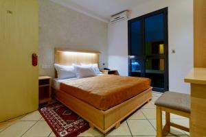 a bedroom with a large bed in a room at Hotel Roma in Tunis