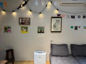 a living room with a couch and pictures on the wall at Bao Dao Da Lou in Suao