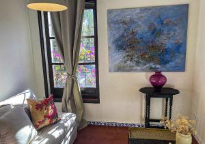 a living room with a couch and a window at Hotel Masía de Altea in Altea