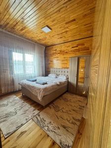 a bedroom with a bed and a wooden ceiling at Ertunç Turizm in Kahramanmaraş