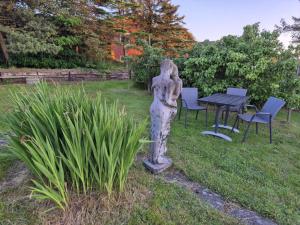 a statue of a woman standing in a garden at Studiolejlighed I Hvide Sande Centrum in Hvide Sande +3 photos
